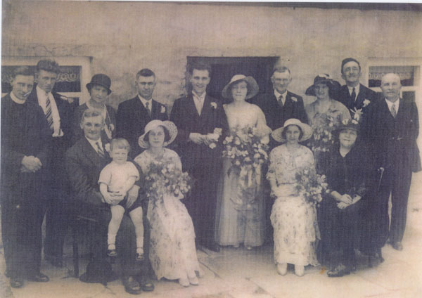 Copy of an undated photograph of Lizzie and Willie Roach's wedding. Left to Right � Back Row � Rev Lewis, Unknown, ? Isaacs, Dennis Lewis, Willie Roach, Lizzie Roach (nee Rogers) Jimmy Rogers, Flossie Lewis, John Rogers, Willie John, Front Row � Tommy Roach, (Glyndwr Lewis on knee) Megan Jones (nee Stokes), Lorna Bevan (nee Hutchings), Katie Rogers
